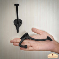 Vintage cast iron wall hook with two prongs