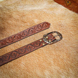 Belt with decorative flower pattern stamped onto belt strap