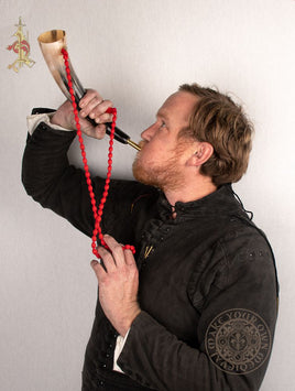 Blowing horn made from cow horn with red string