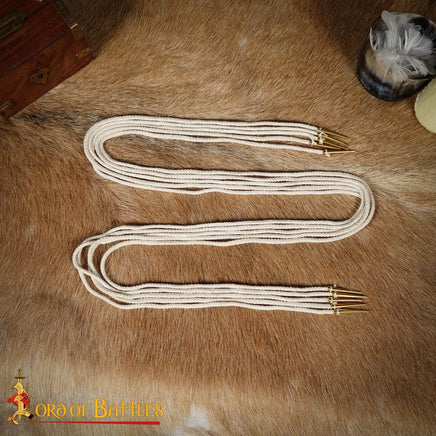 Medieval costume brass aglets on cords with white cord