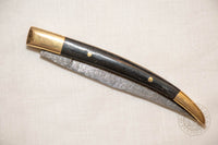 damascus folding knife with horn and brass handle