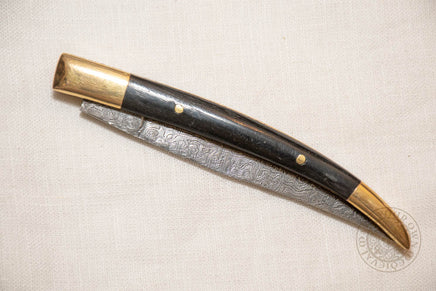 damascus folding knife with horn and brass handle